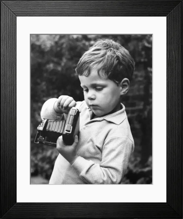 Framed Print : Little boy with a camera in a garden Framed Print : Little boy with a camera in a garden