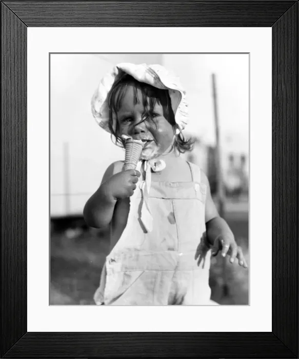 Framed Print : Little girl enjoying an ice cream Framed Print : Little girl enjoying an ice cream
