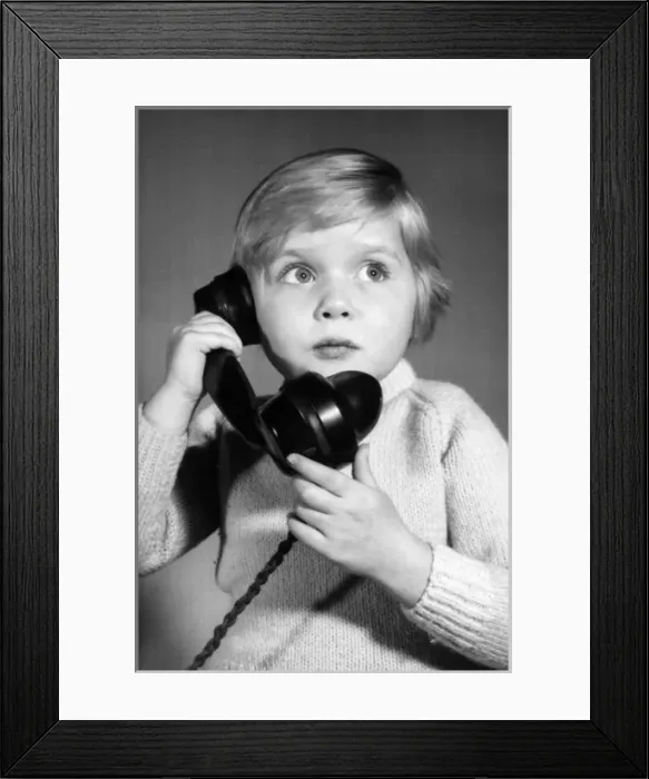 Framed Print : Studio portrait, little boy on the phone Framed Print : Studio portrait, little boy on the phone
