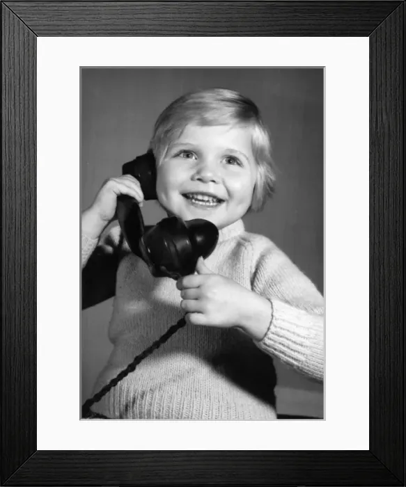 Framed Print : Studio portrait, little boy on the phone Framed Print : Studio portrait, little boy on the phone