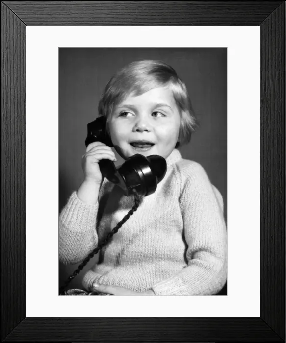 Framed Print : Studio portrait, little boy on the phone Framed Print : Studio portrait, little boy on the phone