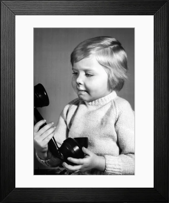 Framed Print : Studio portrait, little boy on the phone Framed Print : Studio portrait, little boy on the phone