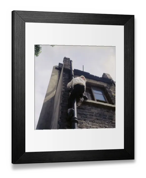 Framed Print : Boy climbing drainpipe on a Balham house, SW London Framed Print : Boy climbing drainpipe on a Balham house, SW London