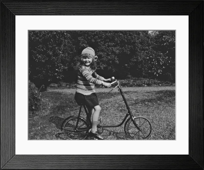 Framed Print : Girl on a bicycle in a garden Framed Print : Girl on a bicycle in a garden