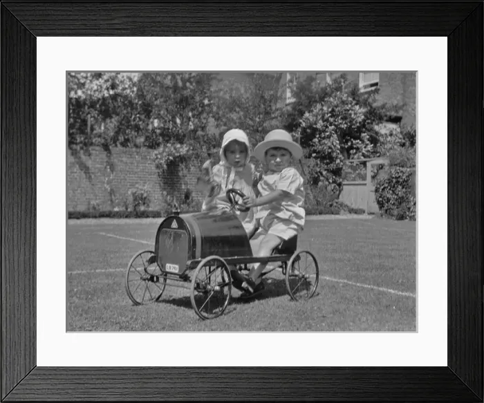 Framed Print : Two toddlers with toy car in a garden Framed Print : Two toddlers with toy car in a garden
