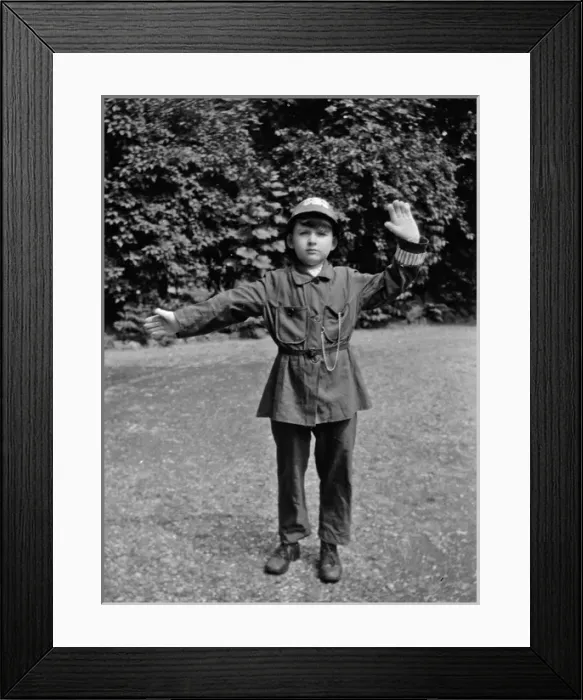 Framed Print : Boy in policemans uniform in a garden Framed Print : Boy in policemans uniform in a garden