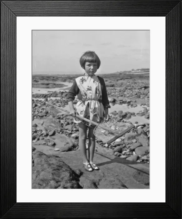 Framed Print : Little girl with fishing net at the seaside Framed Print : Little girl with fishing net at the seaside