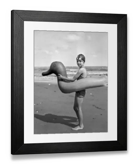 Framed Print : Little girl with rubber ring in the shape of a duck Framed Print : Little girl with rubber ring in the shape of a duck