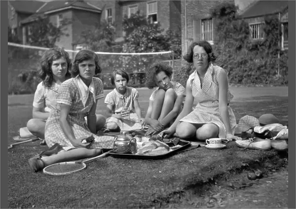 Five girls with tea tray in a garden