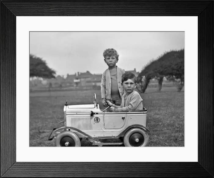 Framed Print : Two boys with toy car in a field Framed Print : Two boys with toy car in a field