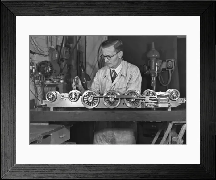 Framed Print : Man in overalls working on miniature train Framed Print : Man in overalls working on miniature train
