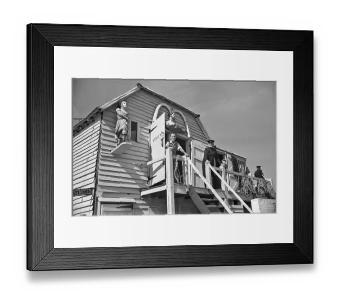 Framed Print : Men at coastal storage hut Framed Print : Men at coastal storage hut