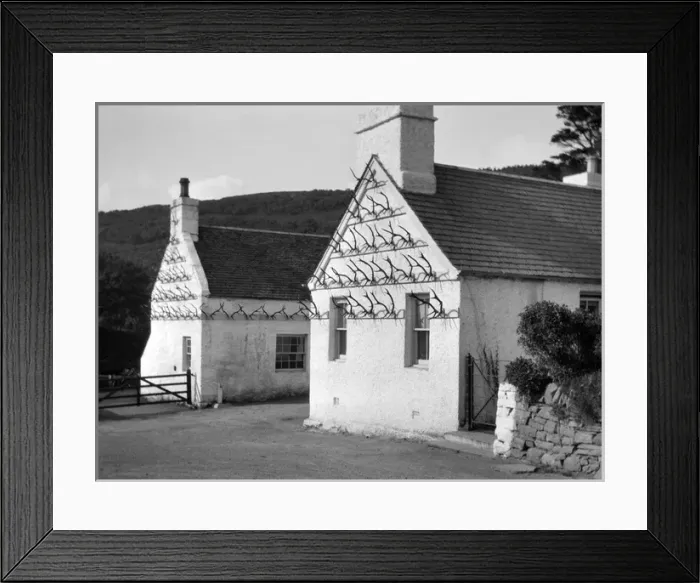 Framed Print : Two whitewashed cottages with antler display Framed Print : Two whitewashed cottages with antler display