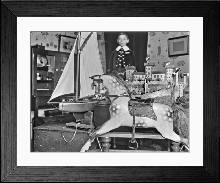 Framed Print : Little boy with rocking horse, sailing boat and castle Framed Print : Little boy with rocking horse, sailing boat and castle