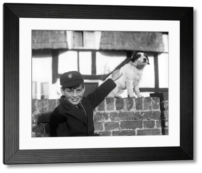 Framed Print : A smiling schoolboy and his terrier dog Framed Print : A smiling schoolboy and his terrier dog