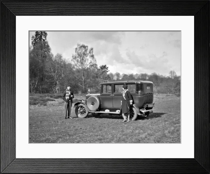Framed Print : Couple relaxing by their car in a field Framed Print : Couple relaxing by their car in a field