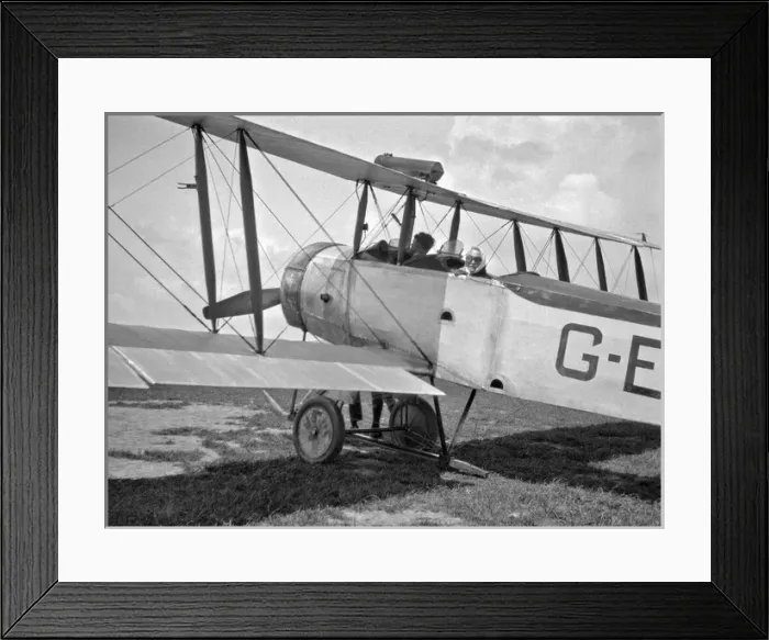 Framed Print : Man and woman in a biplane on an airfield Framed Print : Man and woman in a biplane on an airfield