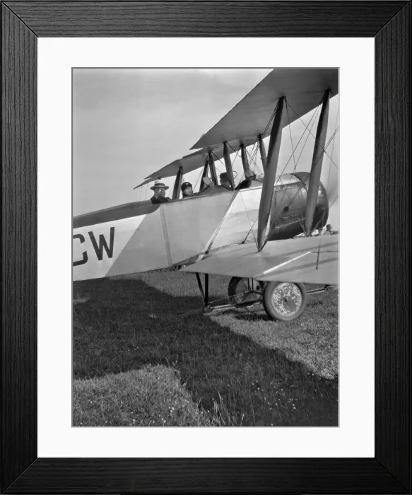 Framed Print : Three people in a biplane on an airfield Framed Print : Three people in a biplane on an airfield