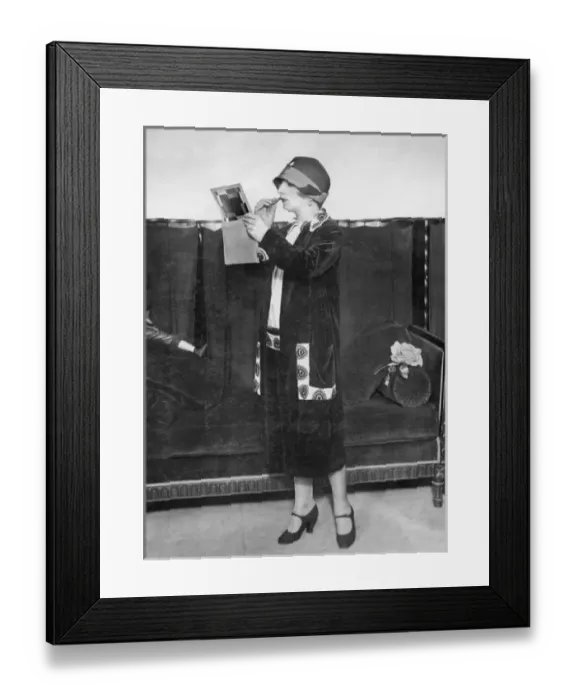 Framed Print : Fashionable woman applying lipstick