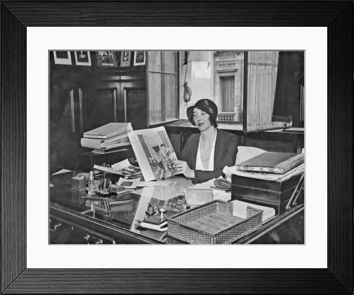 Framed Print : Fashionable woman sitting at a desk Framed Print : Fashionable woman sitting at a desk