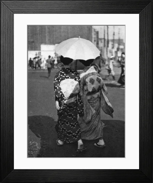 Framed Print : Two Japanese women walk holding a parasol Framed Print : Two Japanese women walk holding a parasol