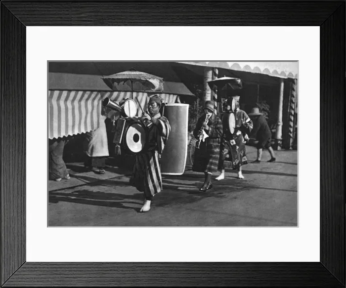 Framed Print : Three Japanese musicians play and walk down a street