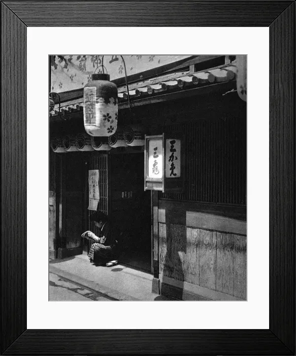 Framed Print : A Japanese girl sits outside a theatre Framed Print : A Japanese girl sits outside a theatre