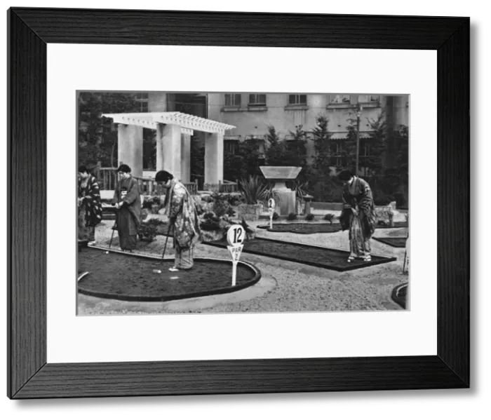 Framed Print : A group of Japanese women play miniature golf Framed Print : A group of Japanese women play miniature golf