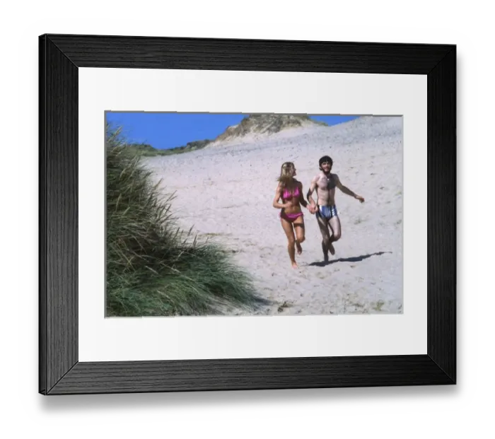 Framed Print : Couple running on a beach, West Country Framed Print : Couple running on a beach, West Country