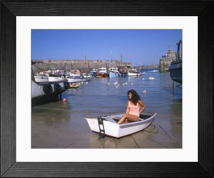 Framed Print : Young woman in a boat at Newquay harbour, Cornwall Framed Print : Young woman in a boat at Newquay harbour, Cornwall