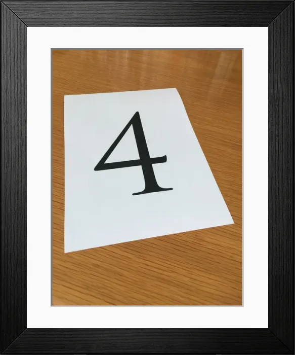 Framed Print : Piece of paper on a desk with a large number 4 Framed Print : Piece of paper on a desk with a large number 4