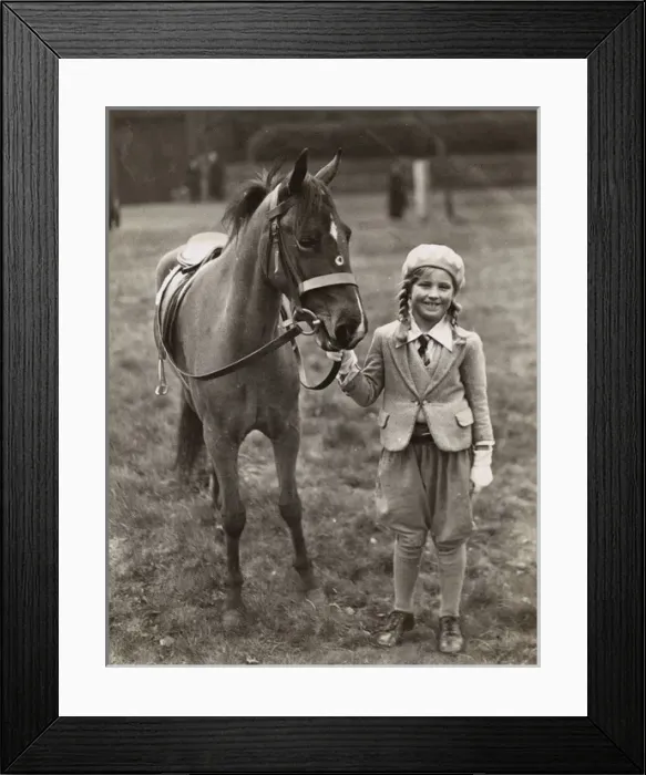 Framed Print : Smiling girl with her pony in a field Framed Print : Smiling girl with her pony in a field