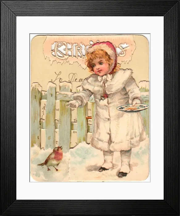 Framed Print : Girl feeding robin in the snow on a Christmas card