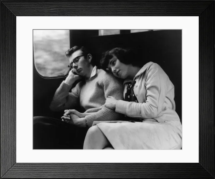 Framed Print : Young couple relaxing in a train compartment Framed Print : Young couple relaxing in a train compartment
