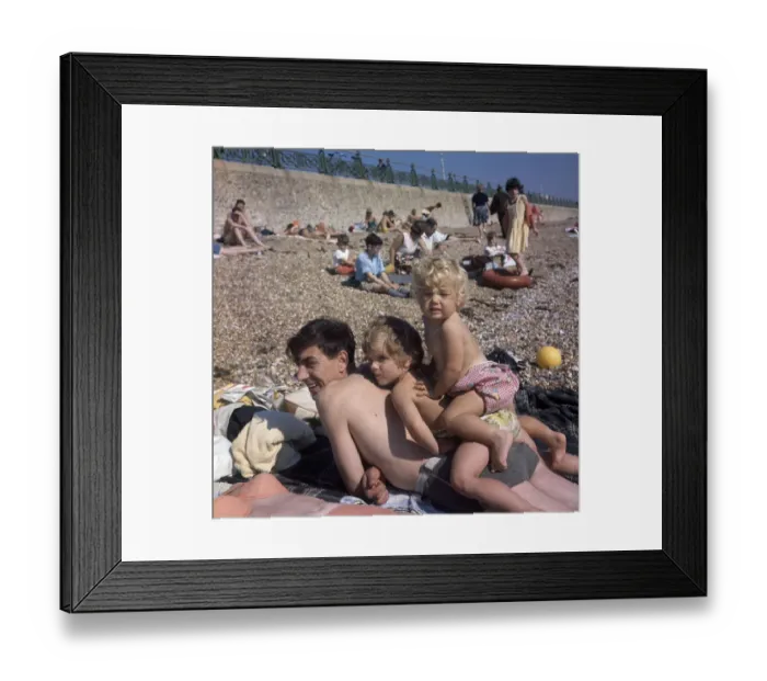 Framed Print : People on holiday on a pebbly beach Framed Print : People on holiday on a pebbly beach