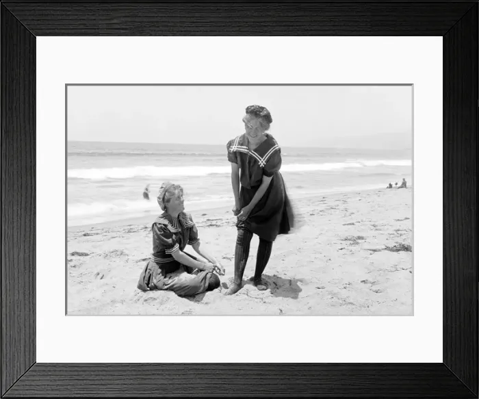 Framed Print : Two women in period bathing suits on the beach in America Framed Print : Two women in period bathing suits on the beach in America