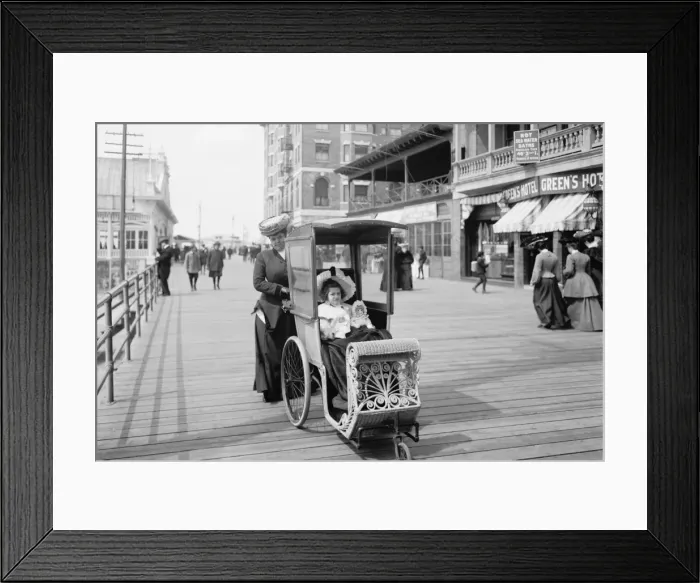 Framed Print : Girl with her doll in a wheeled chair on the Boardwalk, Atla Framed Print : Girl with her doll in a wheeled chair on the Boardwalk, Atla