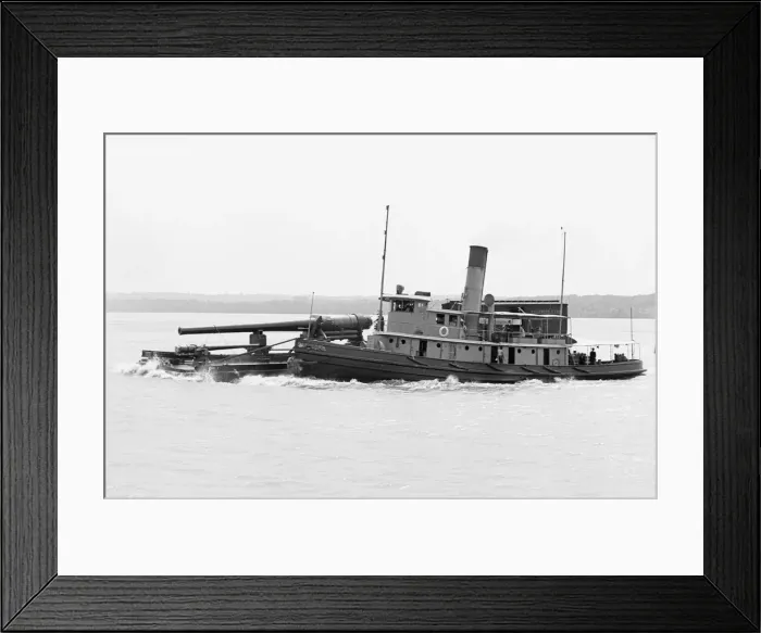 Framed Print : A Tugboat with barge carrying cannon in America Framed Print : A Tugboat with barge carrying cannon in America
