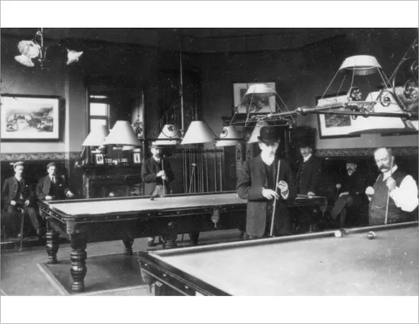 Men playing billiards in a club
