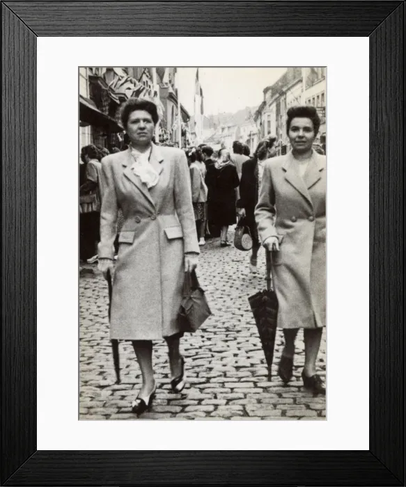 Framed Print : Pair of French twins strolling downing a cobbled street Framed Print : Pair of French twins strolling downing a cobbled street