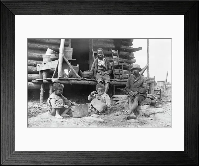 Framed Print : African-American children outside a log cabin in America Framed Print : African-American children outside a log cabin in America