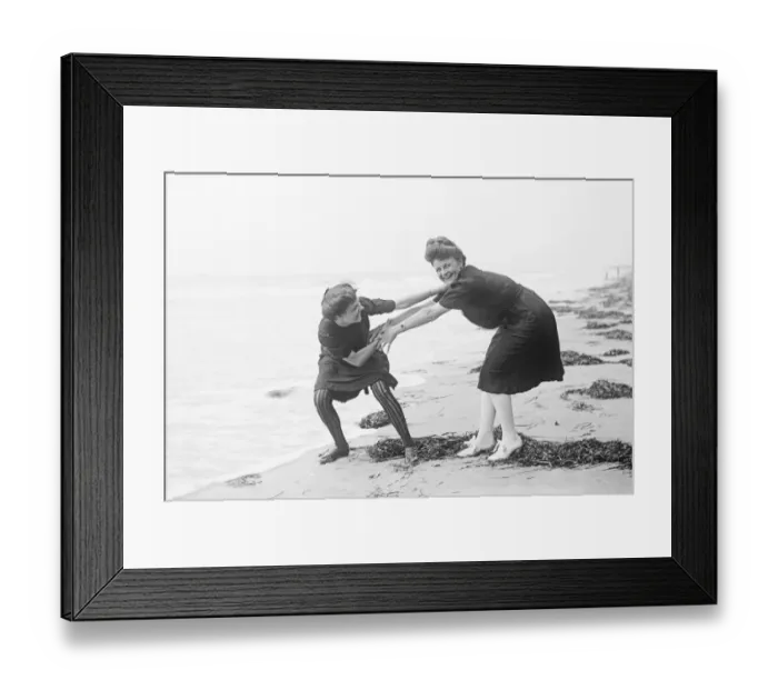Framed Print : Two women in period bathing costumes on the beach in America Framed Print : Two women in period bathing costumes on the beach in America