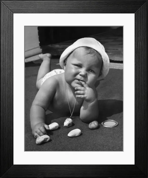 Framed Print : Baby playing with pebbles Framed Print : Baby playing with pebbles