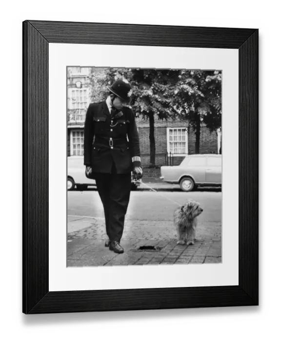 Framed Print : Policeman in a street with a lost dog Framed Print : Policeman in a street with a lost dog