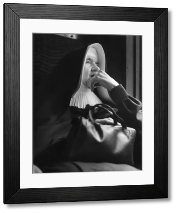 Framed Print : Nun sitting looking thoughtful Framed Print : Nun sitting looking thoughtful