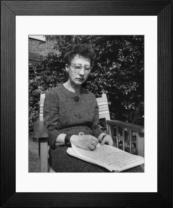 Framed Print : Woman doing automatic writing in a garden Framed Print : Woman doing automatic writing in a garden