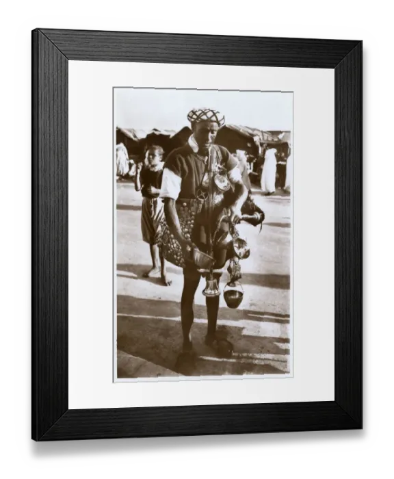 Framed Print : Moroccan water carrier with containers and bell Framed Print : Moroccan water carrier with containers and bell
