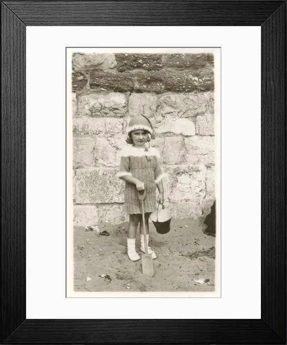 Framed Print : Young girl in remarkable woollen ensemble on beach Framed Print : Young girl in remarkable woollen ensemble on beach