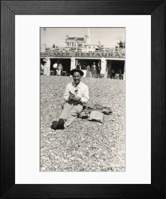 Framed Print : Jolly British gent sitting on beach in front of a restaurant Framed Print : Jolly British gent sitting on beach in front of a restaurant