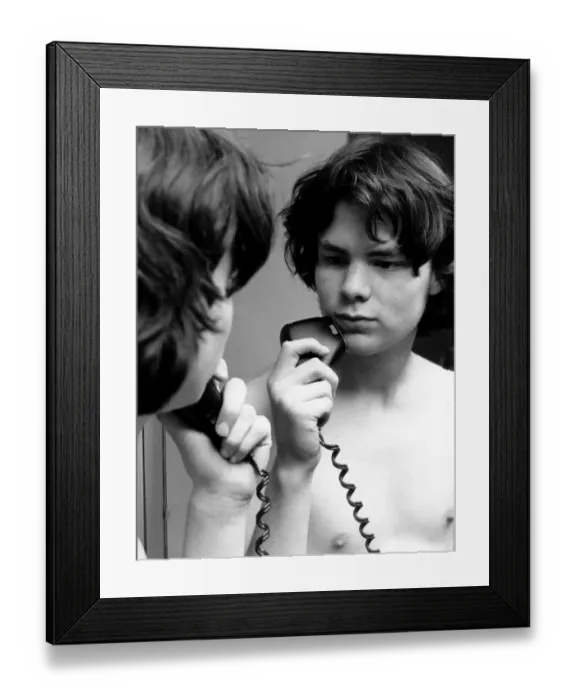Framed Print : Young lad using an electric razor Framed Print : Young lad using an electric razor